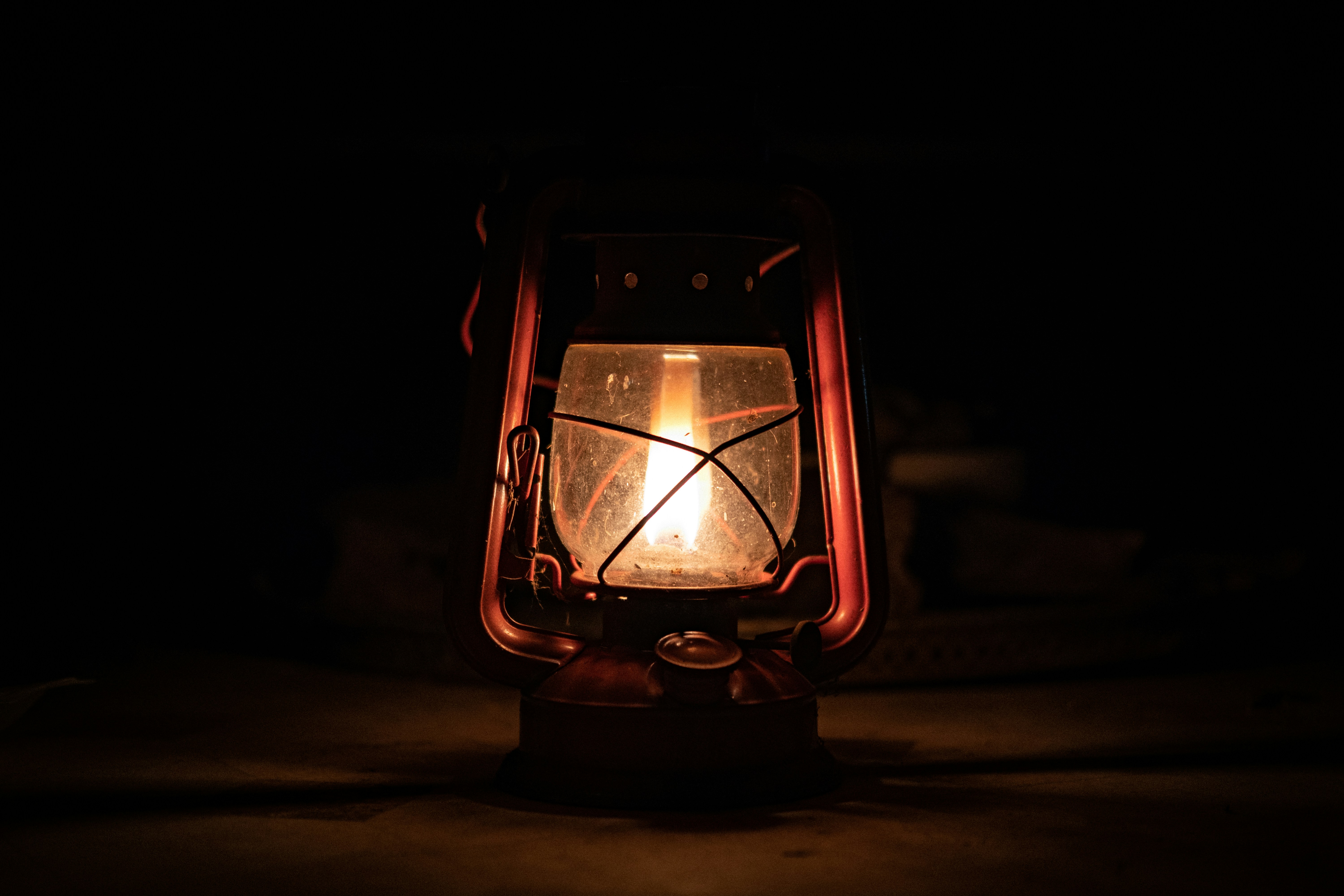 A lit lantern glowing in the dark